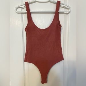 Selling pink ribbed bodysuit